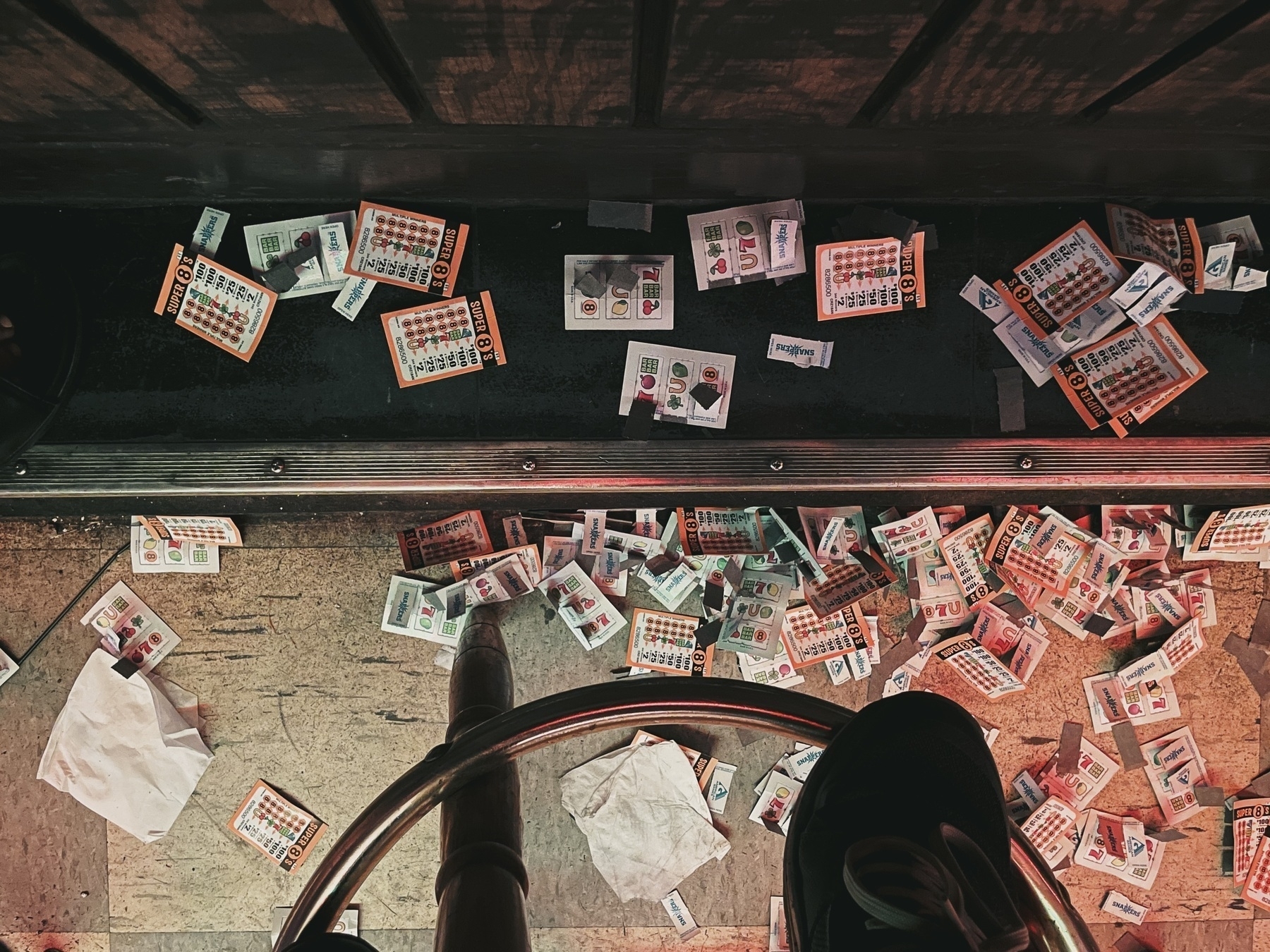 Looking down at floor with piles of pull-tabs