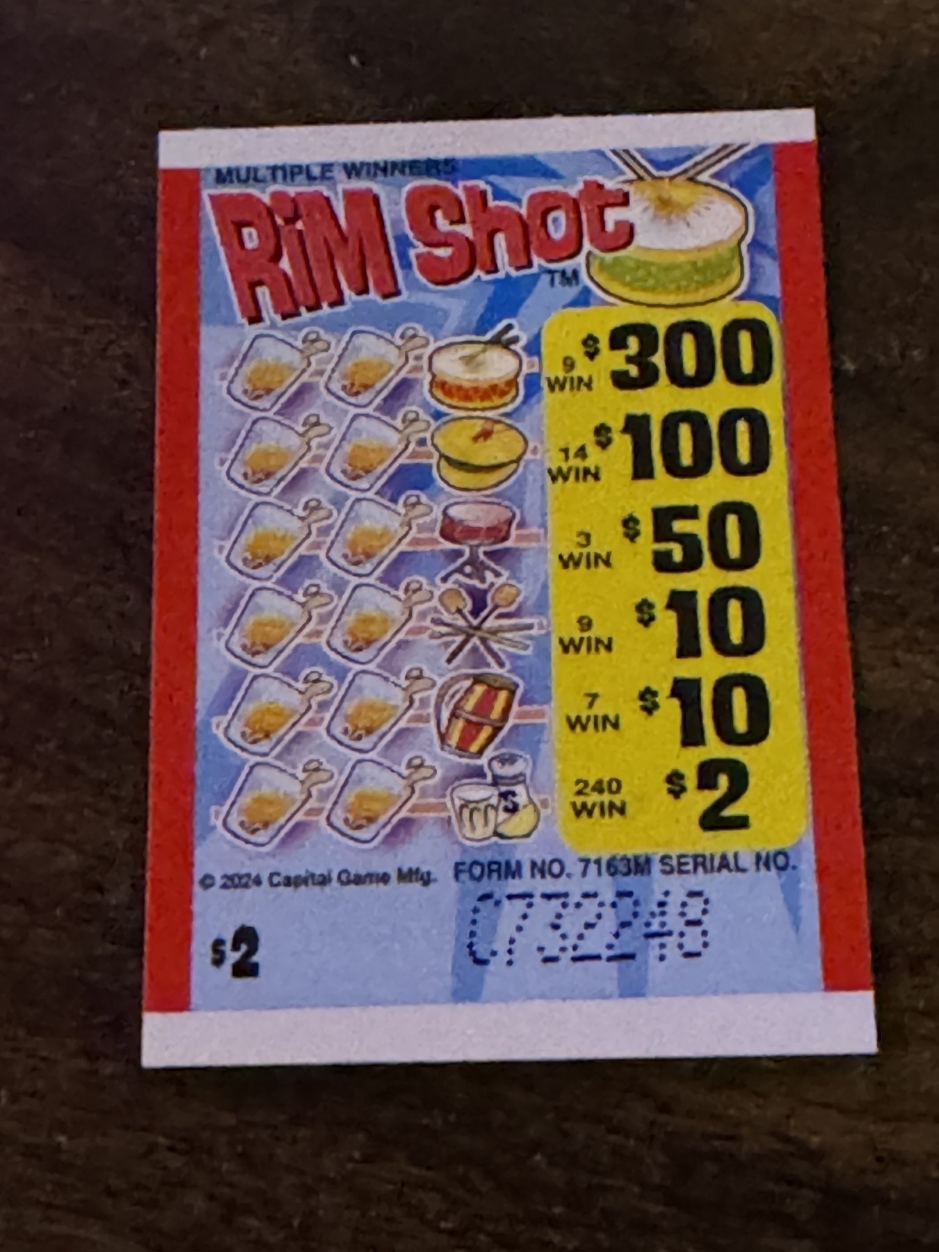 Auto-generated description: A pull-tab ticket titled Rim Shot with various prize amounts and matching symbols.